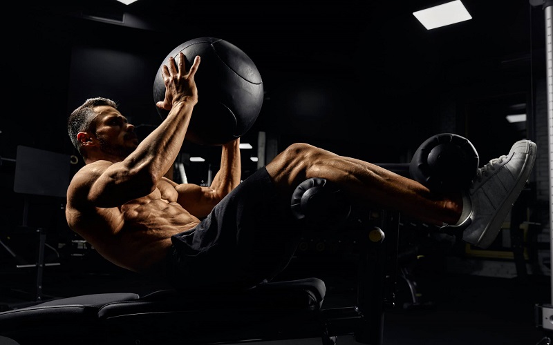 man building core muscles with ball scaled 1